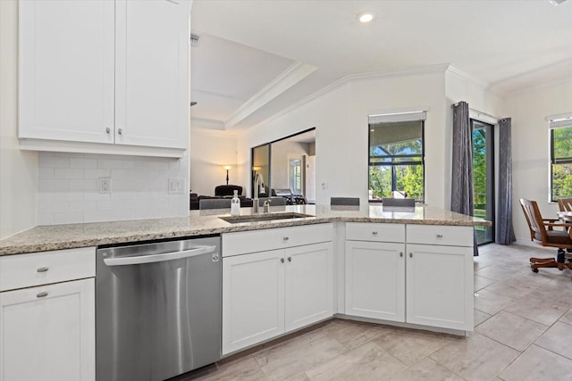 kitchen featuring light stone counters, dishwasher, crown molding, and a sink