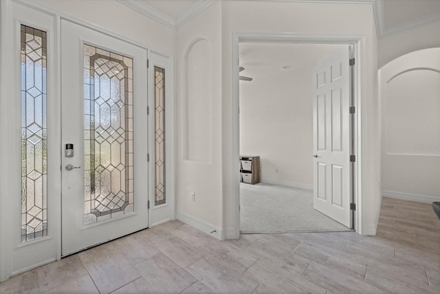 entrance foyer with crown molding and baseboards