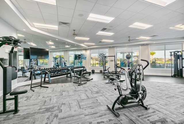 workout area with visible vents, a healthy amount of sunlight, and a paneled ceiling