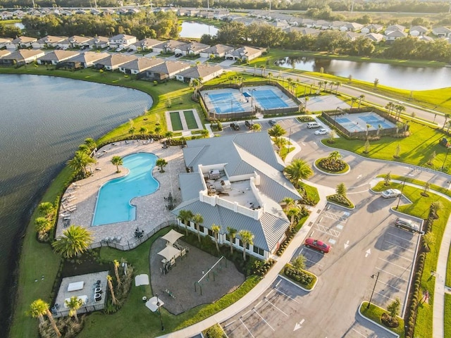 drone / aerial view featuring a water view and a residential view