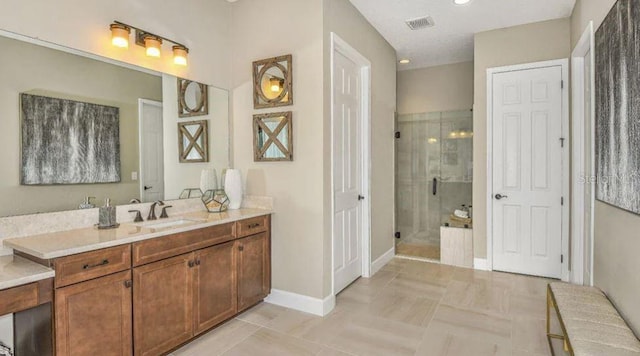 bathroom with visible vents, baseboards, vanity, and a shower stall