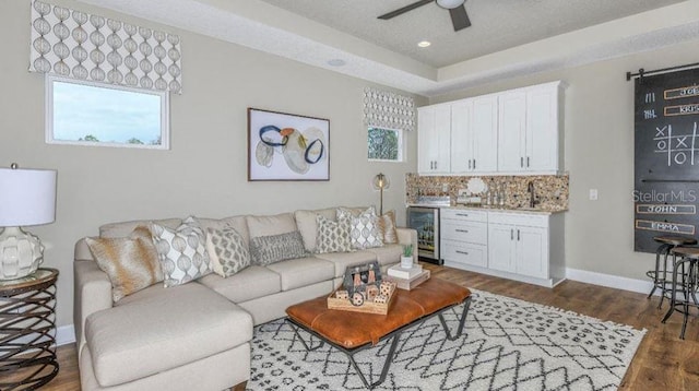 living room with beverage cooler, dark wood-style floors, recessed lighting, baseboards, and ceiling fan