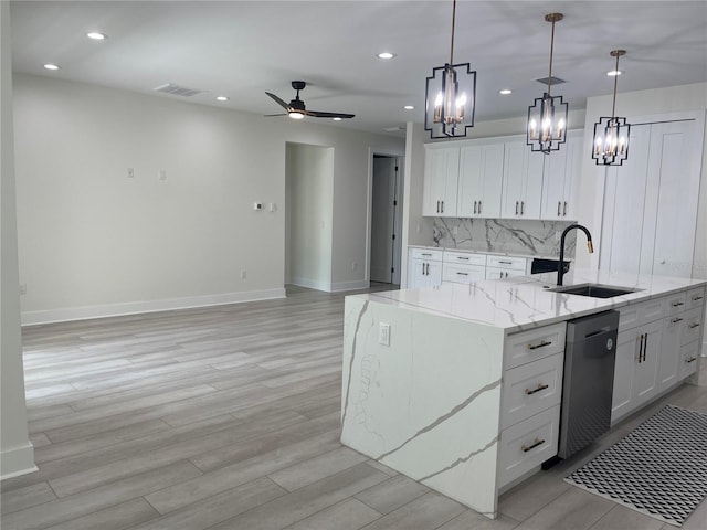 kitchen with visible vents, ceiling fan with notable chandelier, a sink, stainless steel dishwasher, and open floor plan