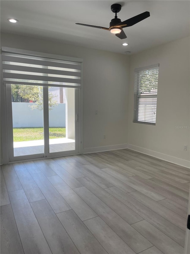 empty room featuring recessed lighting, wood finished floors, baseboards, and ceiling fan