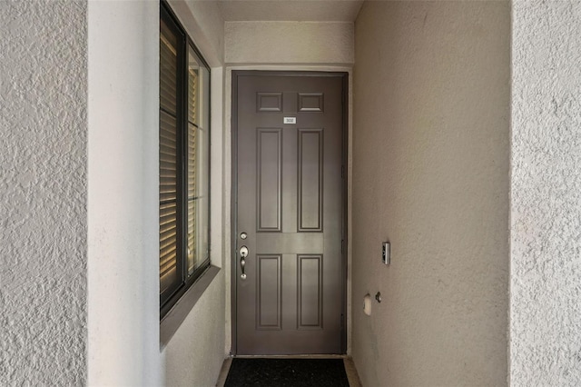 entrance to property with stucco siding