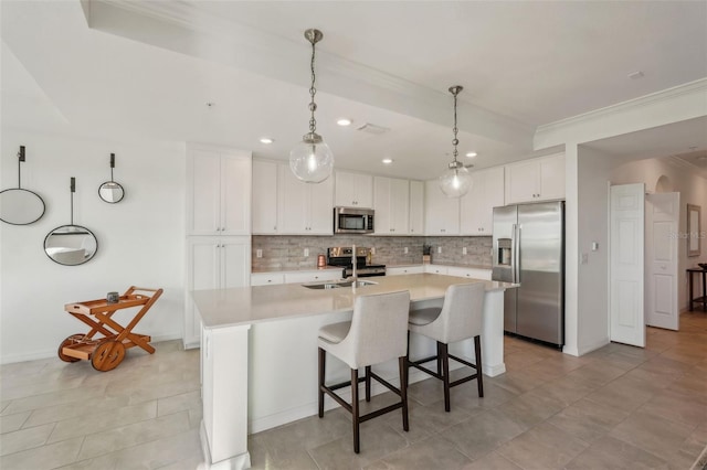 kitchen featuring light countertops, white cabinets, tasteful backsplash, and stainless steel appliances