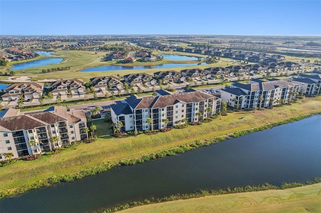 drone / aerial view featuring a residential view and a water view