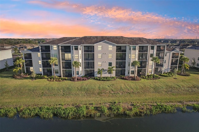 view of property featuring a residential view and a water view