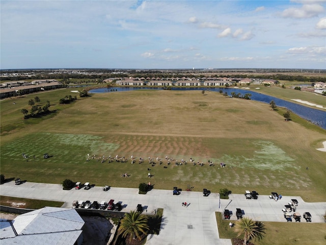 aerial view with golf course view and a water view