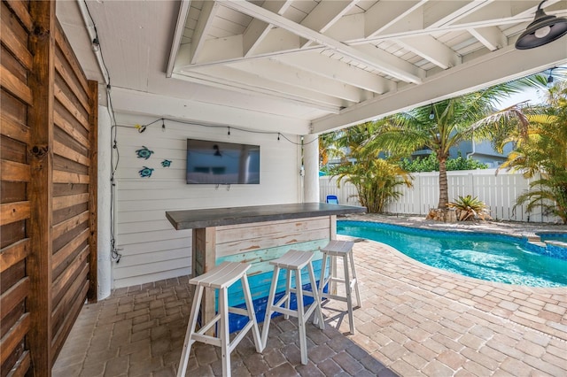 view of swimming pool featuring a fenced in pool, outdoor dry bar, a patio, and a fenced backyard