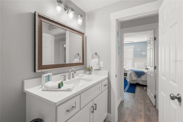 ensuite bathroom featuring wood-type flooring, connected bathroom, and vanity