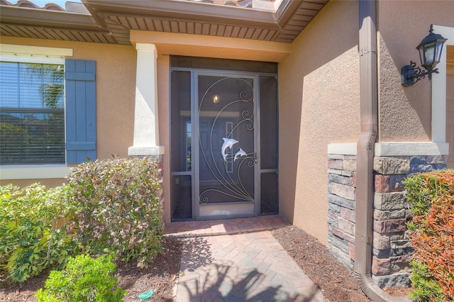 entrance to property featuring stucco siding