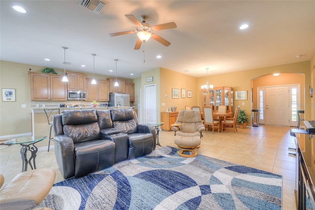 living room with light tile patterned flooring, visible vents, ceiling fan with notable chandelier, and recessed lighting