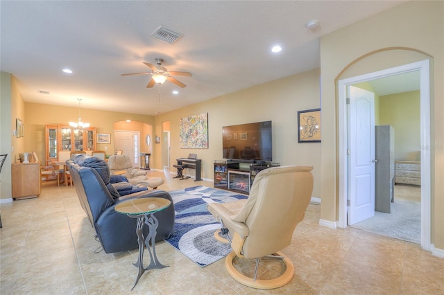 living area featuring recessed lighting, visible vents, and ceiling fan with notable chandelier