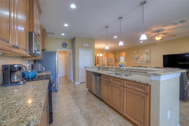 kitchen featuring a sink, stainless steel appliances, and brown cabinetry