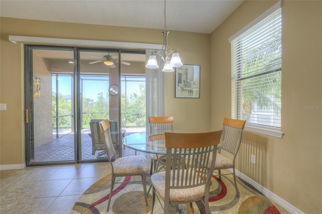 dining space featuring tile patterned floors, a ceiling fan, and baseboards