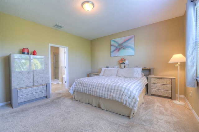 bedroom featuring visible vents, baseboards, a textured ceiling, and carpet flooring