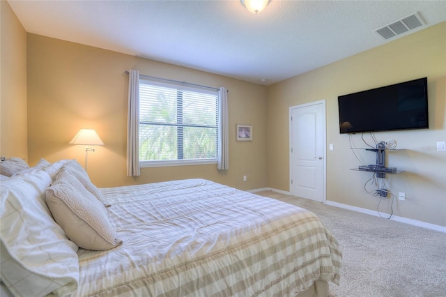 carpeted bedroom with visible vents and baseboards