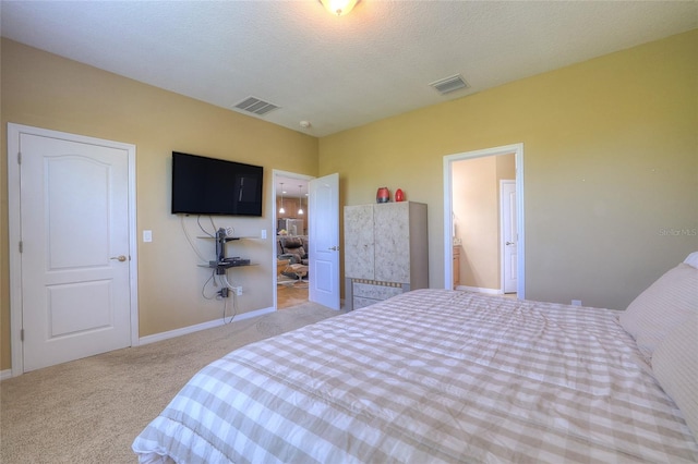 bedroom with baseboards, carpet, visible vents, and a textured ceiling