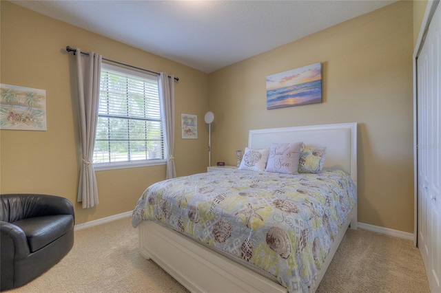 carpeted bedroom featuring baseboards