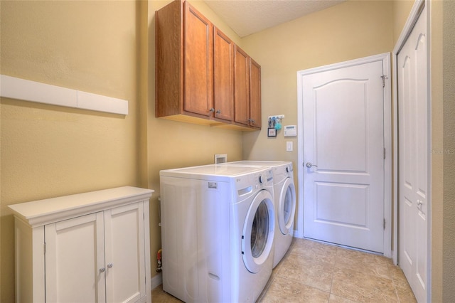 washroom featuring cabinet space and separate washer and dryer