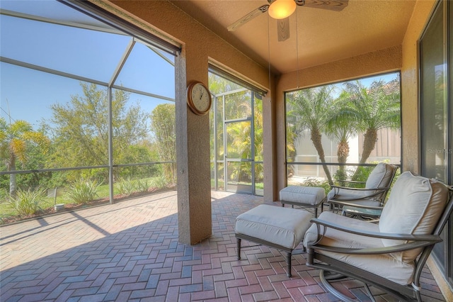 sunroom featuring a ceiling fan