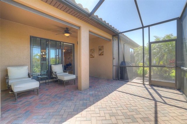 unfurnished sunroom featuring a ceiling fan