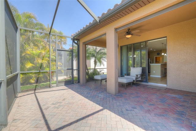 unfurnished sunroom with ceiling fan