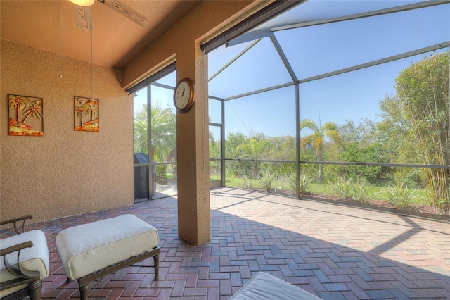 sunroom featuring a ceiling fan