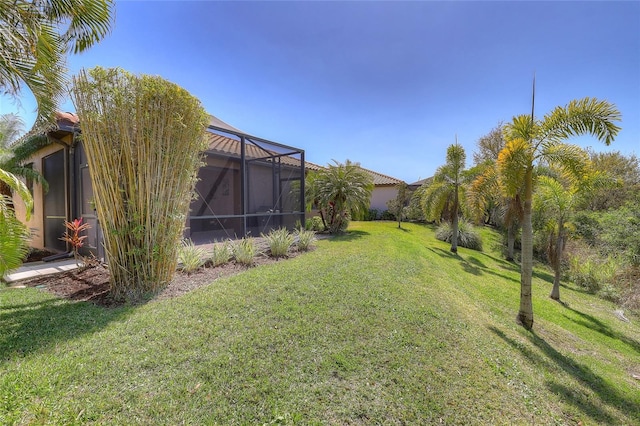 view of yard featuring glass enclosure