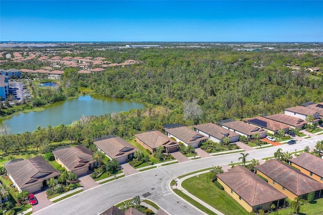 birds eye view of property featuring a forest view, a residential view, and a water view