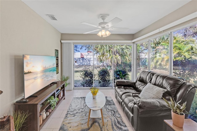 living room featuring light tile patterned floors, visible vents, a healthy amount of sunlight, and a ceiling fan