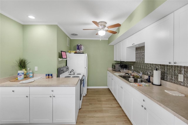 kitchen with range with electric cooktop, a sink, stainless steel microwave, crown molding, and ceiling fan