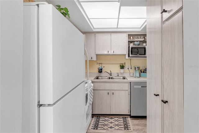 kitchen featuring light countertops, open shelves, appliances with stainless steel finishes, and a sink