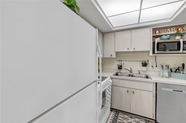 kitchen with light countertops, appliances with stainless steel finishes, and a sink