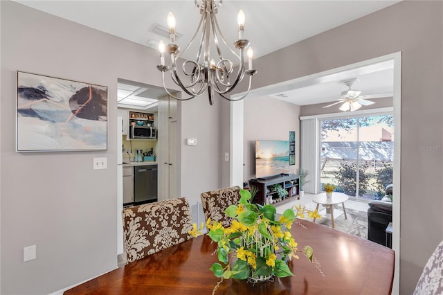 dining space featuring ceiling fan with notable chandelier