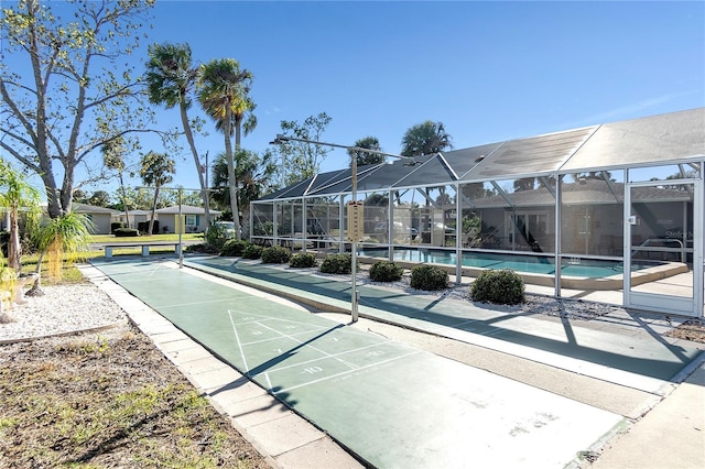 view of property's community with a residential view, shuffleboard, and a pool