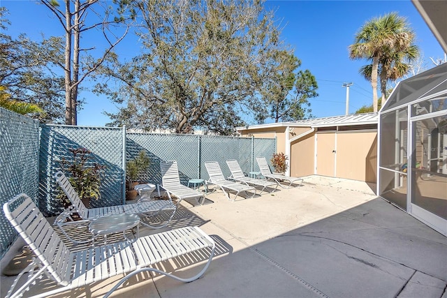 view of patio with a lanai and a fenced backyard