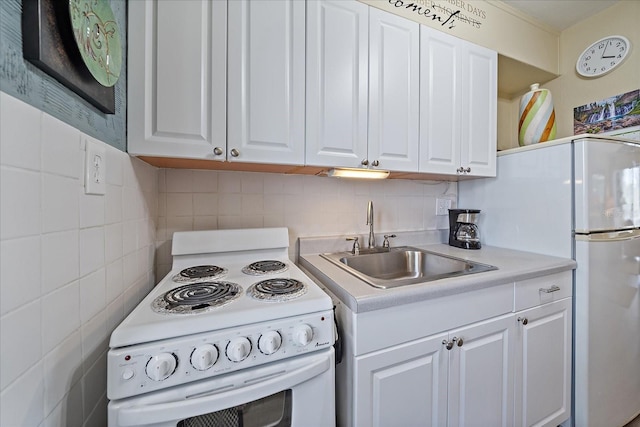 kitchen featuring a sink, tasteful backsplash, white cabinetry, white appliances, and light countertops