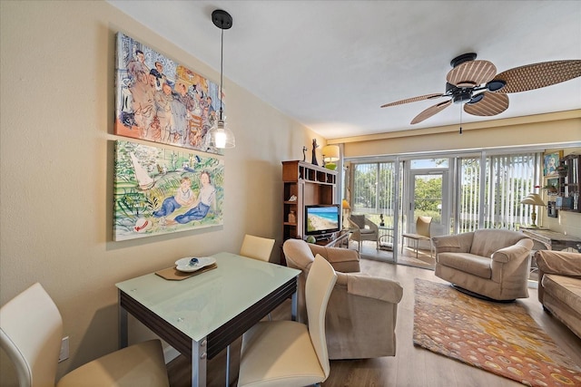 living area featuring wood finished floors and a ceiling fan