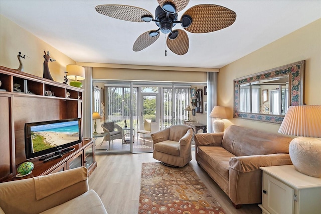 living room featuring light wood finished floors and ceiling fan