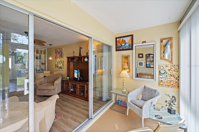 sitting room with a ceiling fan and wood finished floors