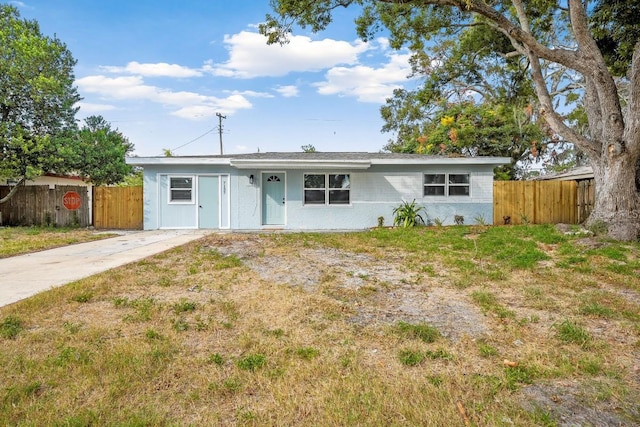 ranch-style house featuring fence