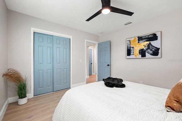 bedroom with a closet, visible vents, light wood-style flooring, and baseboards