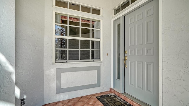 view of exterior entry featuring stucco siding