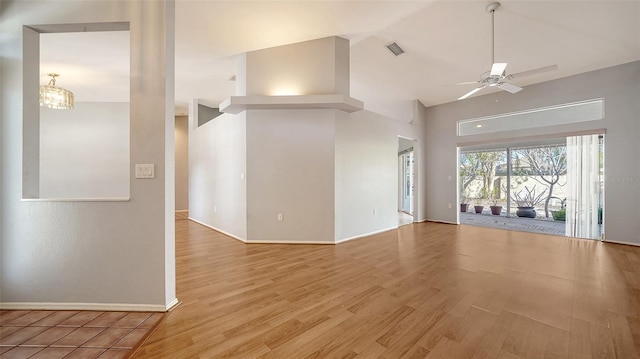 unfurnished living room featuring visible vents, high vaulted ceiling, ceiling fan with notable chandelier, wood finished floors, and baseboards