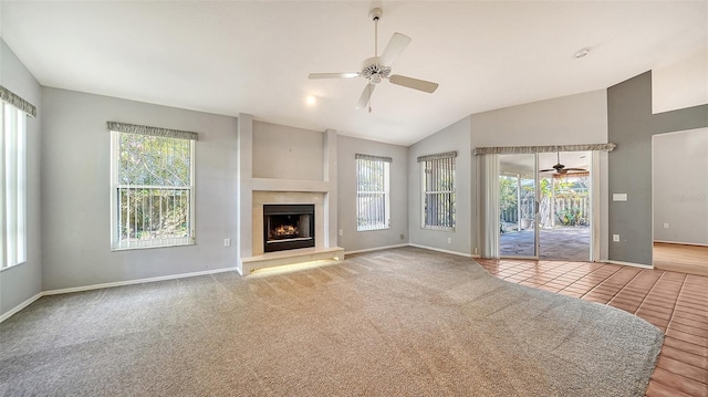 unfurnished living room with carpet, a healthy amount of sunlight, and a ceiling fan