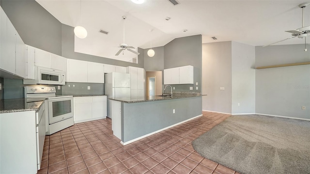 kitchen featuring white appliances, light tile patterned floors, a sink, ceiling fan, and white cabinetry