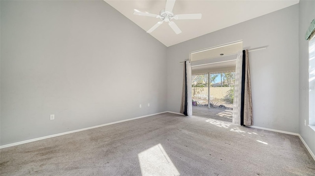 carpeted spare room with high vaulted ceiling, a ceiling fan, and baseboards