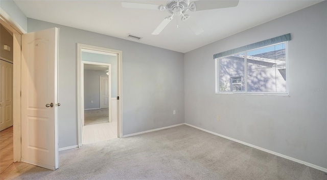 unfurnished bedroom featuring visible vents, ceiling fan, baseboards, and carpet